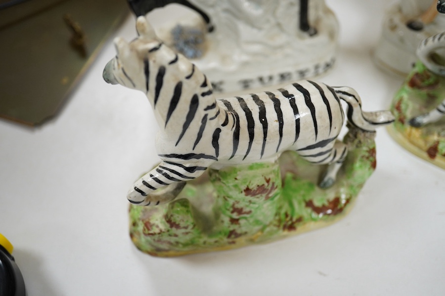 A pair of 19th century Staffordshire pottery models of Zebra, two pairs of Staffordshire pottery equestrian groups, largest 21cm high (6) Condition - some minor breaks and repairs